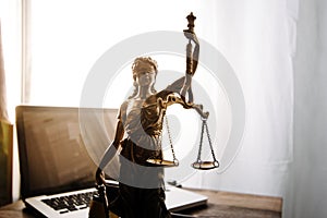 law legal technology concept. judge gavel on computer with scales of justice on desk of lawyer