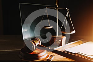 law legal technology concept. judge gavel on computer with scales of justice on desk of lawyer