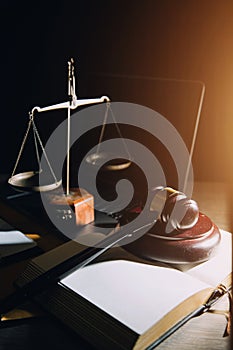 law legal technology concept. judge gavel on computer with scales of justice on desk of lawyer