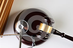 Law mallet or Judge gavel and medical stethoscope photo