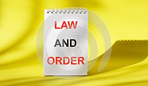 Law and order, the text is written on a notebook. photo