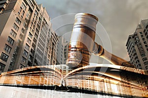 Law protection. Double exposure of book with gavel, cityscape