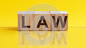 LAW Word On Wooden Blocks on yellow background. Law and Justice, Legality concep