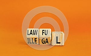 Lawful or illegal symbol. Concept word Lawful or Illegal on wooden cubes. Beautiful orange table orange background. Business