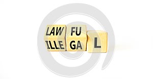 Lawful or illegal symbol. Concept word Lawful or Illegal on wooden cubes. Beautiful white table white background. Business lawful
