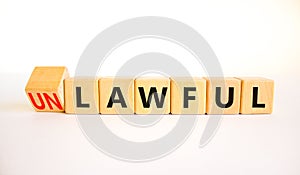 Lawful or unlawful symbol. Turned wooden cubes and changed the concept word Unlawful to Lawful. Beautiful white table white