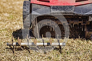 Lawn care - old grass removal and soil aeration with scarifier