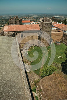 Lawn on castle central courtyard among stone walls and tower