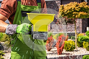 Lawn Fertilization with Handheld Broadcast Spreader Closeup