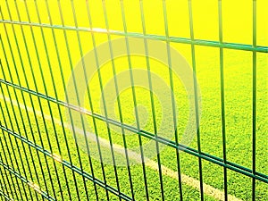 Lawn field for playing minifootball behind the fence mesh