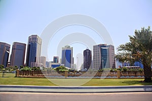 Lawn in front of Abu Dhabi tall buildings.