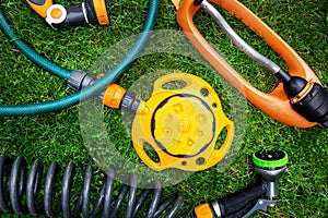 Lawn and garden watering equipment. sprinklers and nozzles on grass background