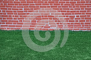 Lawn of grass and brick wall