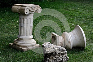 Lawn with green grass and white marble sculptures, courtyard details with architecture and plants