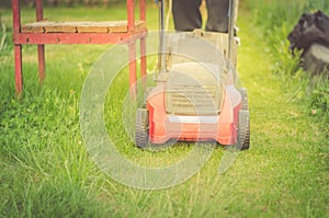 Lawn mower cuts a lawn/red lawn mower cuts a lawn