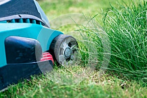 Lawn mower cutting green grass