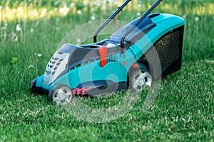 Lawn mower cutting green grass