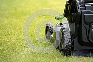 Lawn mower on a green grass