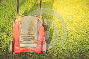 Lawn mower on the green grass/lawn mower on the green grass. Copyspace