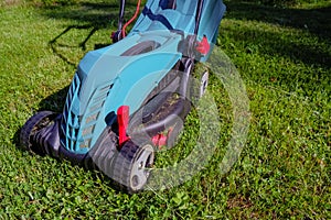 Lawn mower on green grass. mower cutting fresh grass in backyard, garden service.equipment, mowing, gardener, care, work