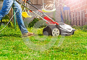 Lawn mower man using walk behind lawnmower