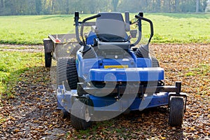 Lawn mower in the middle of a meadow