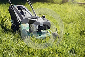 Lawn mower mowing the long grass