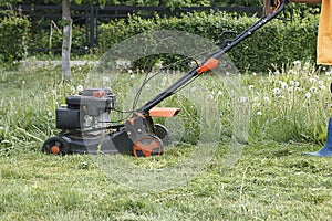 Lawn mower in the Park, on the lawn mowing the grass