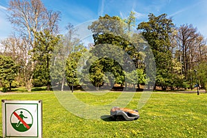 Lawn Mower Robot and Prohibition Sign of Not to Walk on the Grass