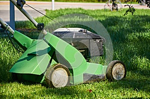lawn mower stands on the grass