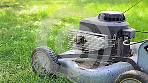 Lawn mower stands on the grass