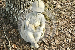 A lawn ornament of a child and book