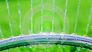 Lawn sprinkler spaying water over green grass