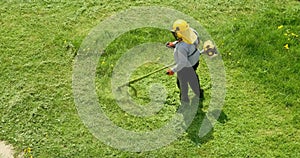 Lawnmover man worker cutting dry grass with lawn mower