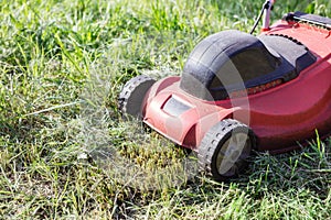 Lawnmower on green grass in the garden