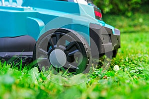 Lawnmower on a lawn in summer garden. Mowing the grass in the garden.Garden equipment and tools.cutting grass