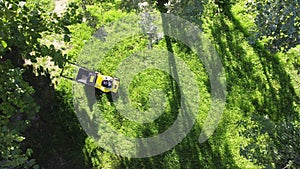 lawnmower top view on the lawn. mowing the lawn in the backyard