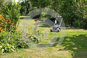 Lawnmower and wheelbarrow in the garden