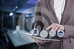 Laws, legal information and online consultation. Woman using tablet. Icons over device photo