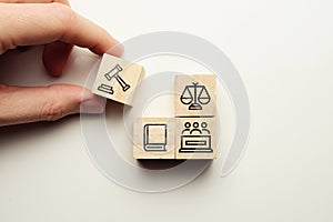 Lawsuit concept with jury icons, law book on wooden cubes photo