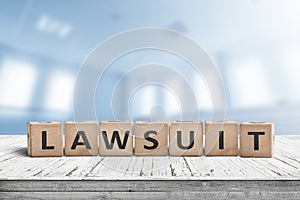 Lawsuit sign on a wooden table