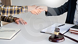 Lawyer or attorneys shaking hand with client after consultation discussing a contract agreement customer at courtroom, judge