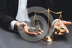 Lawyer in black suit with golden scale balance in office. equility