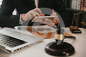 Lawyer business man working with tablet and paperwork on his desk in office workplace for consultant lawyer in office