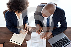 Lawyer, consulting and documents with a business team working on a desk in an office from above. Contract, meeting or