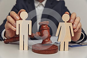 Lawyer or counselor holds figures of family, divorce or separation concept. Close-up