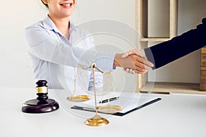 Lawyer is currently shaking hands with the client about the success in resolving the case