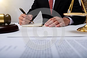 Lawyer Detail of a judge sitting at his desk, studying new laws and legislation and taking notes