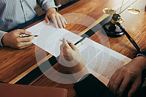 Lawyer is explaining about the wrongdoing laws regarding fraud to the client at the office