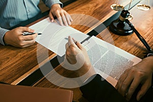 Lawyer is explaining about the wrongdoing laws regarding fraud to the client at the office